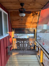 Swinging benches on both ends of the front screened porch.