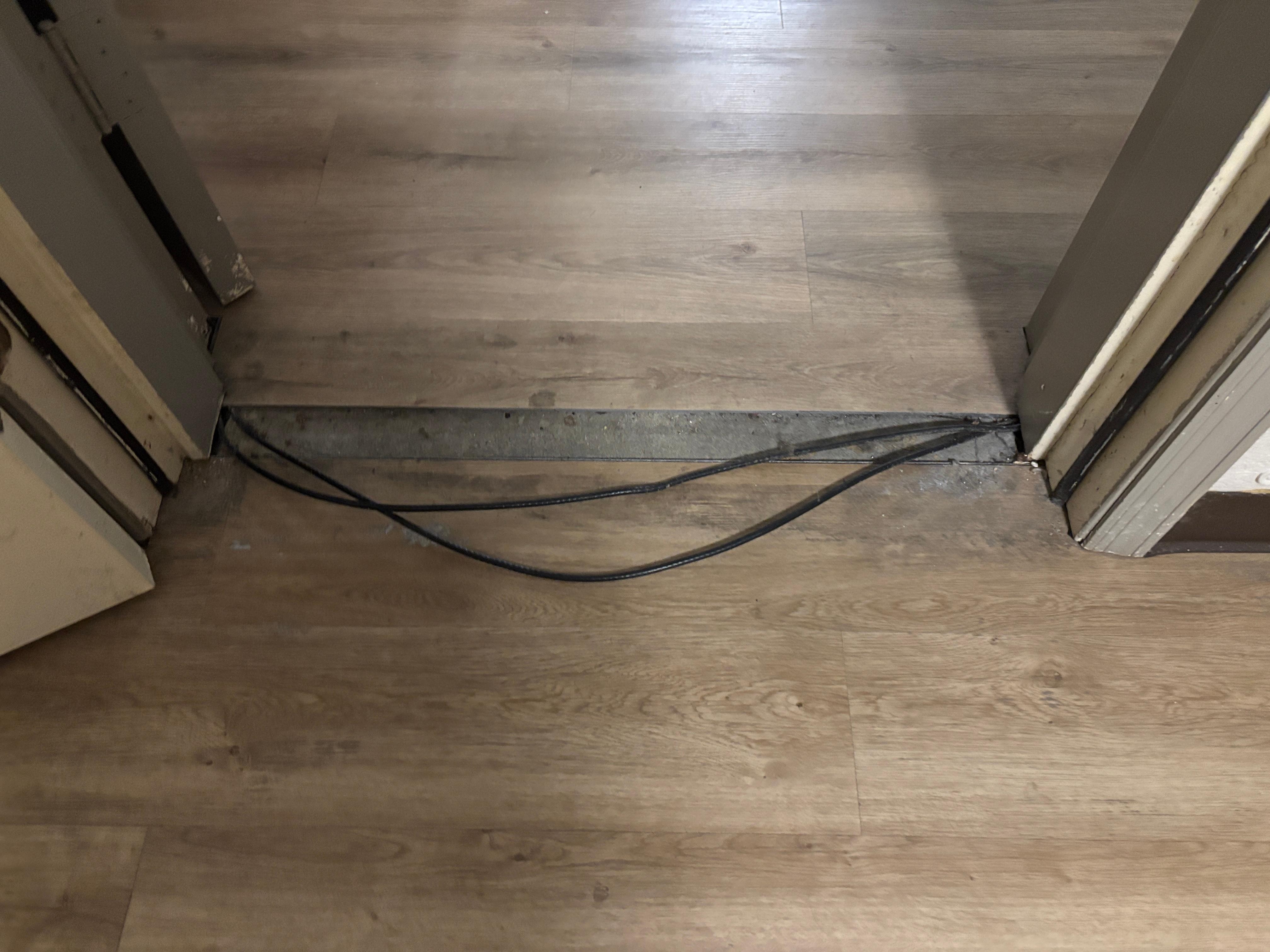 Floor transition and loose wires in between the two rooms