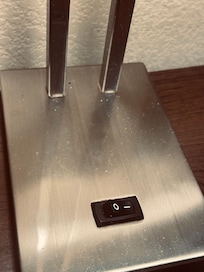 Dust on nightstand and lamp.