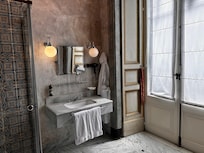 Deluxe room bathroom vanity. The doors overlook the alleyway.