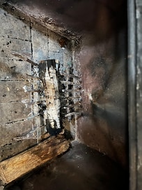 the fireplace was filled with smelly old half-burned logs.