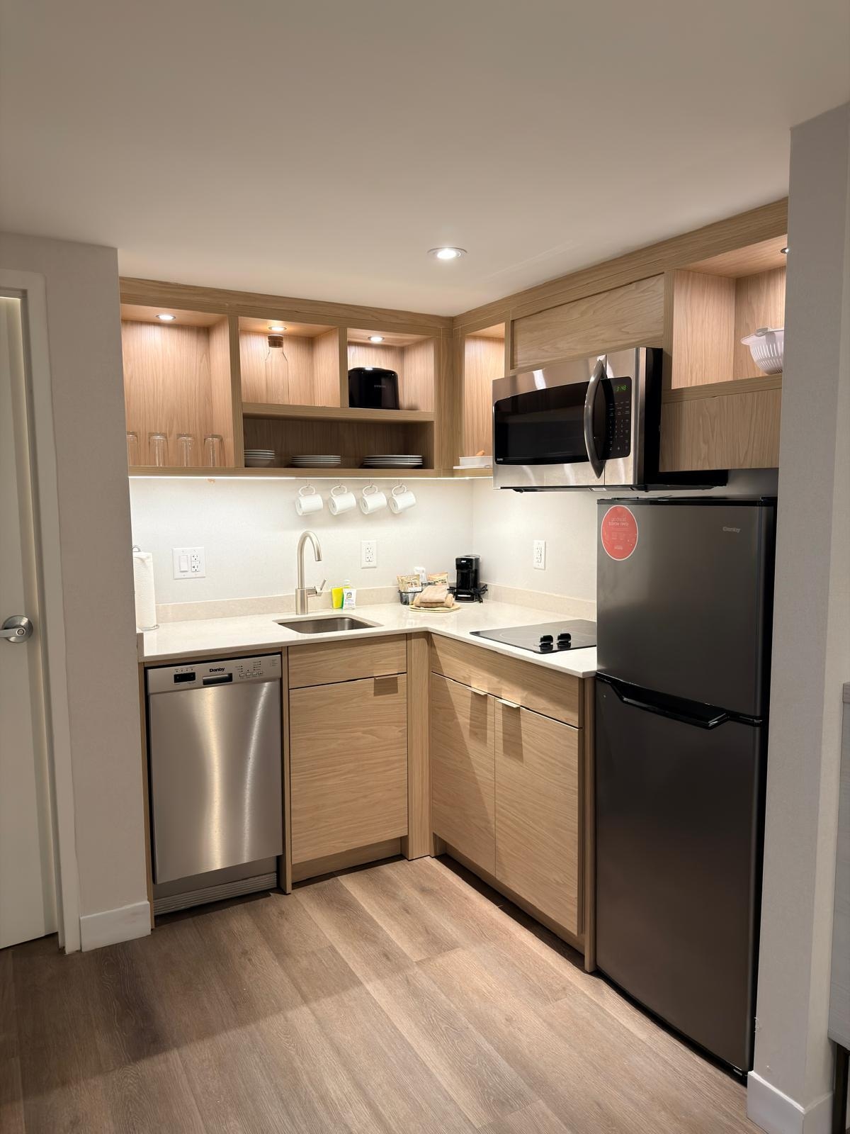 Kitchen with cutlery and pots and all appliances.