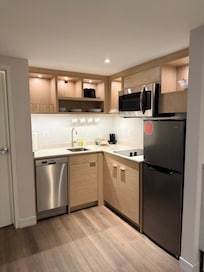 Kitchen with cutlery and pots and all appliances.