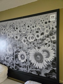 Sticker of hotel name on the picture on the wall. So someone doesn't steal it? It is the size of the king bed.