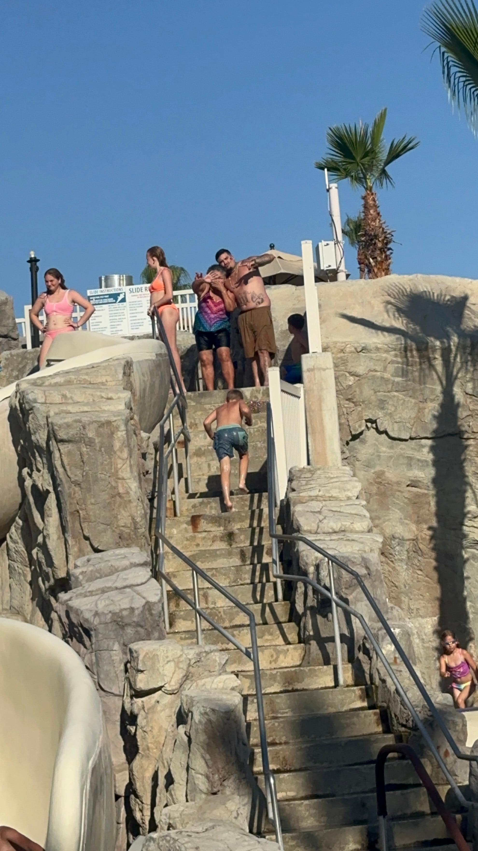 Mom and hubby going down the big slide