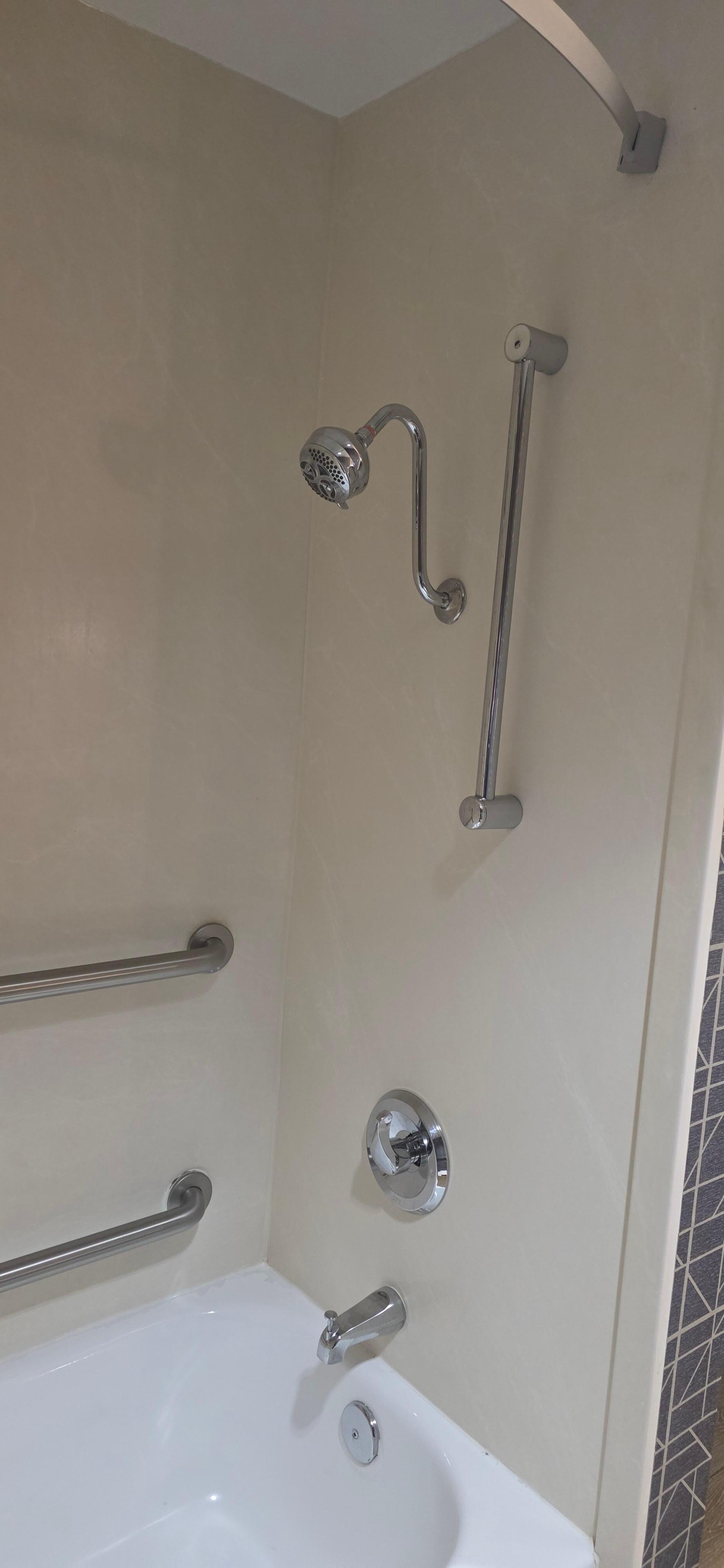 Shower head at chest height. Must bend down to rinse hair 