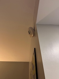 The alarm was hanging off the wall