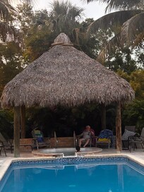 Thatched roof over hot tub hangout popular for us as much as the pool!
