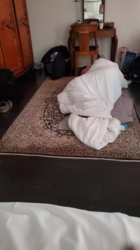 Our son sleeping on the floor on our bed quilt. We were in a Deluxe, larger room.