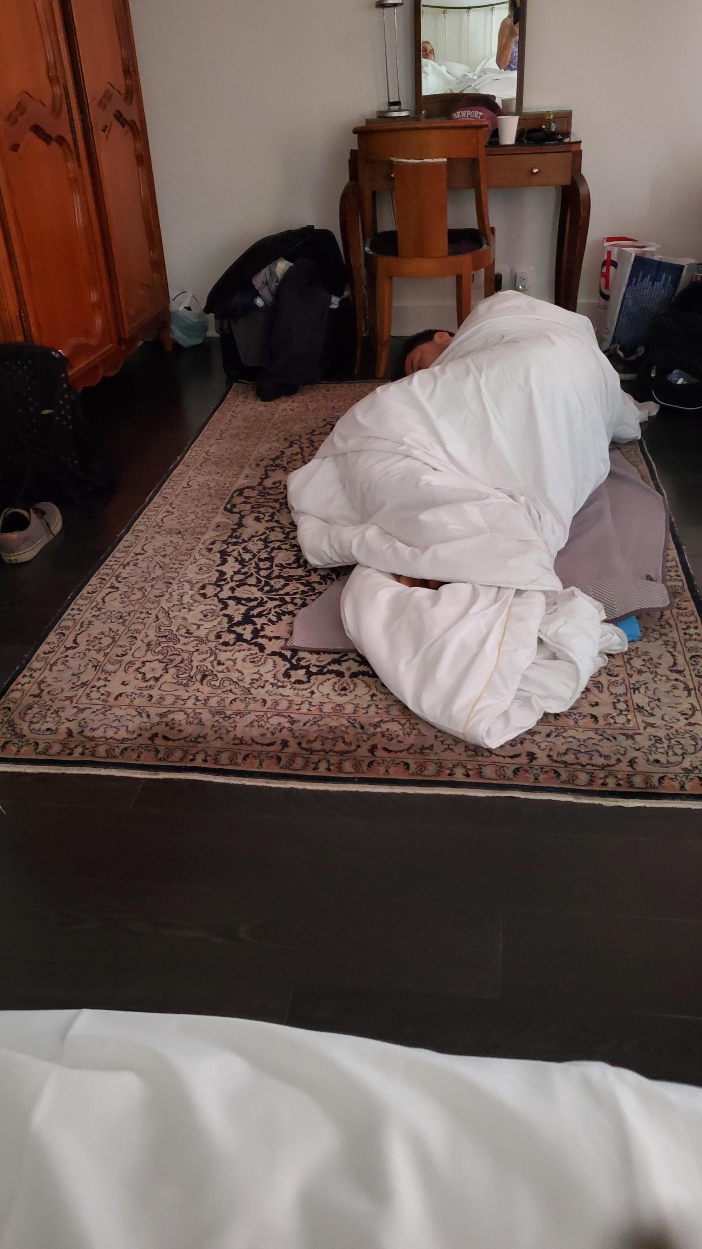 Our son sleeping on the floor on our bed quilt.  We were in a Deluxe, larger room.