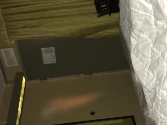 Inside of dark room curtin wrapped around door handle to close gap.