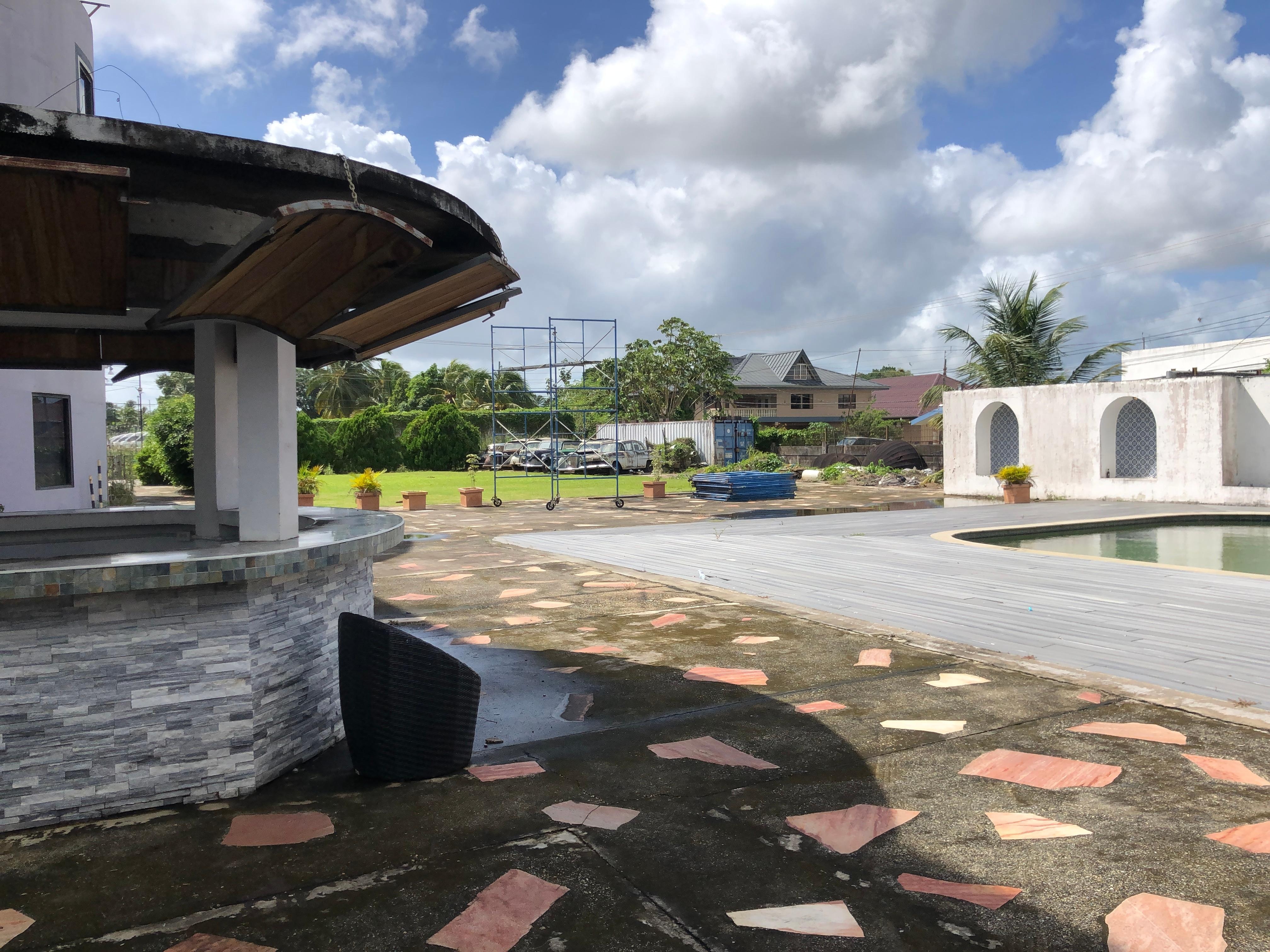 Pool not available and pool area surrounded by rusty cars
