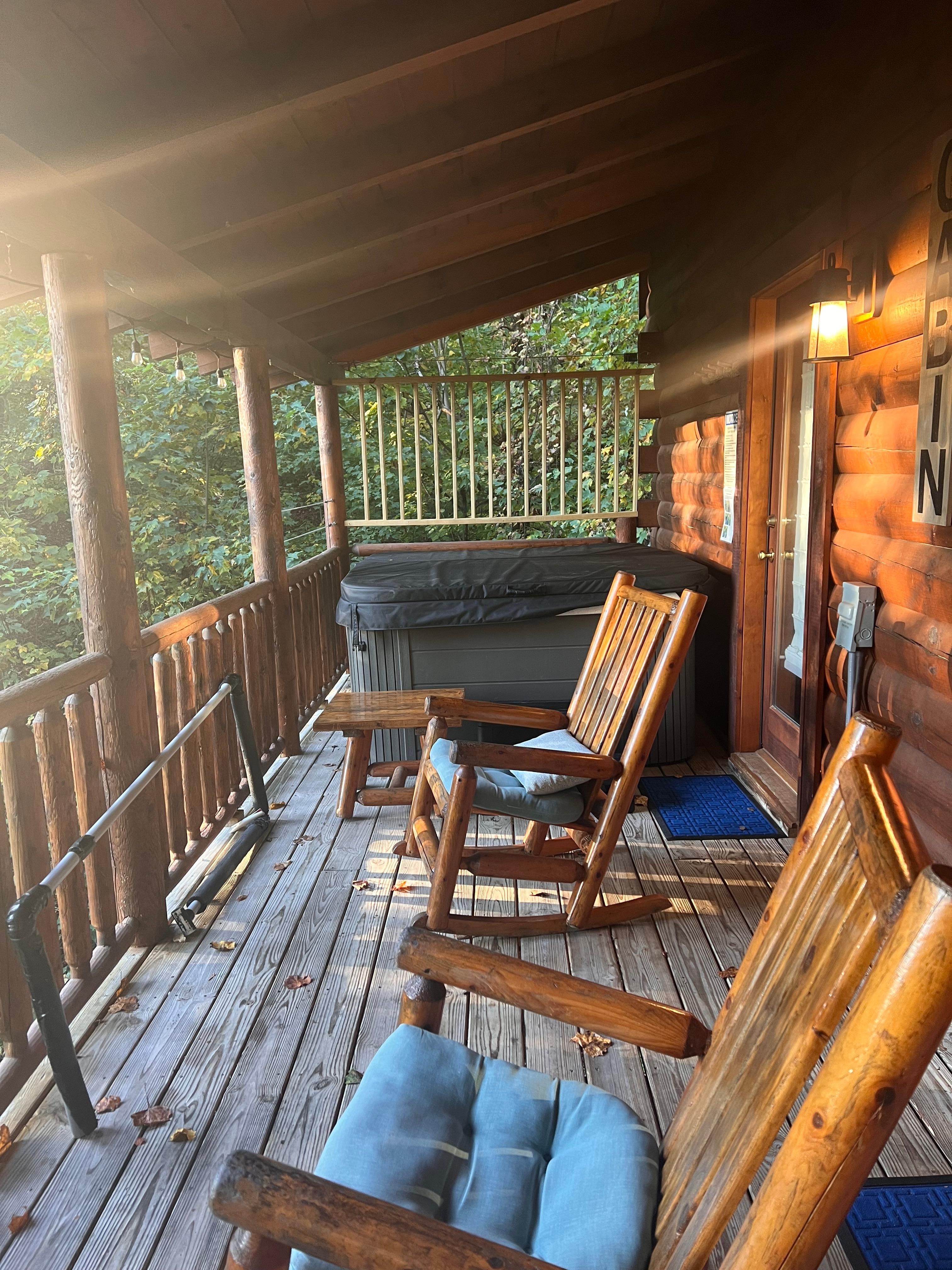 Back porch with bench, rocking chairs & hot tub.