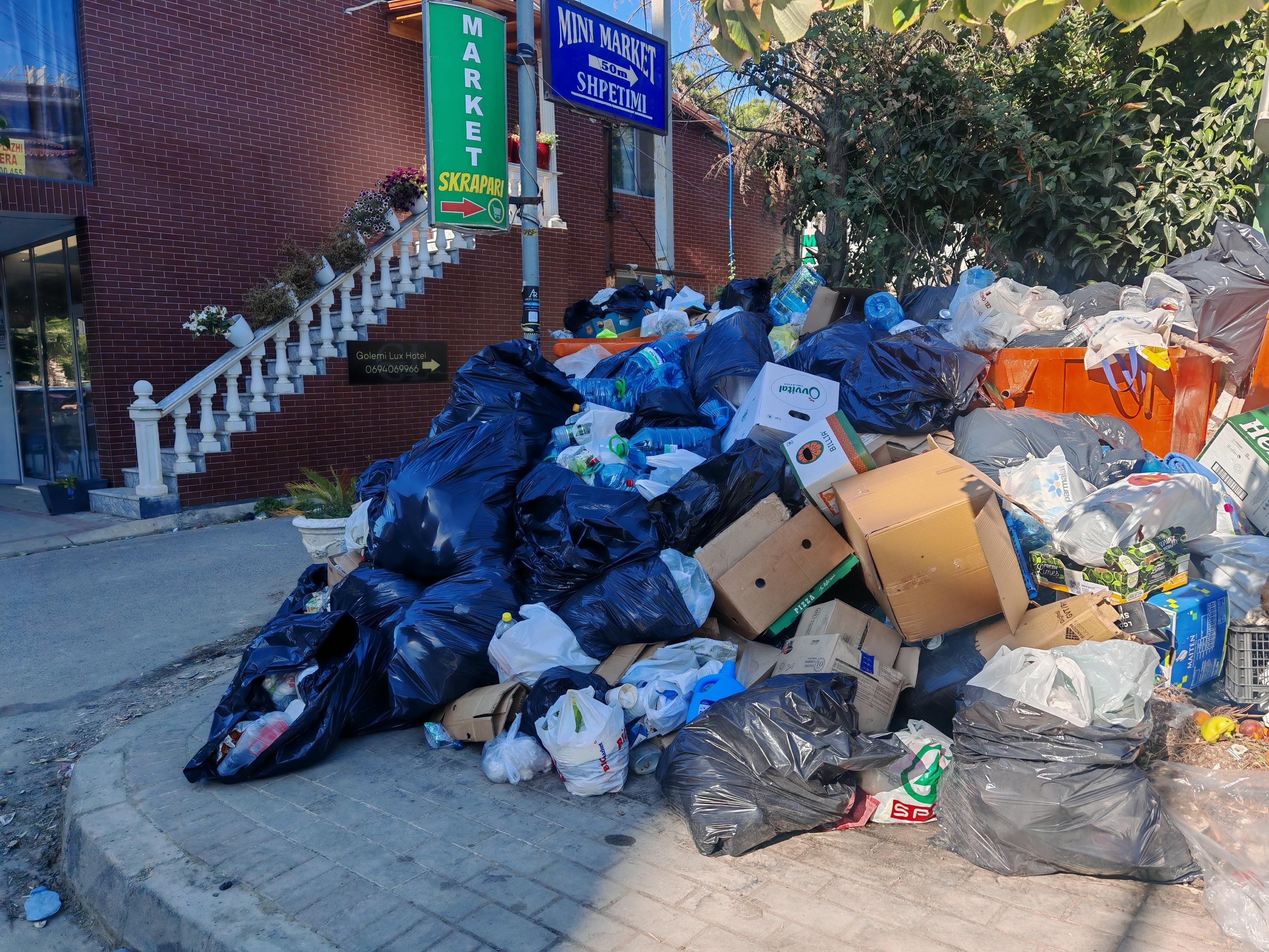 Entrance to the hotel with overflooded waste bins