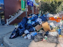 Entrance to the hotel with overflooded waste bins