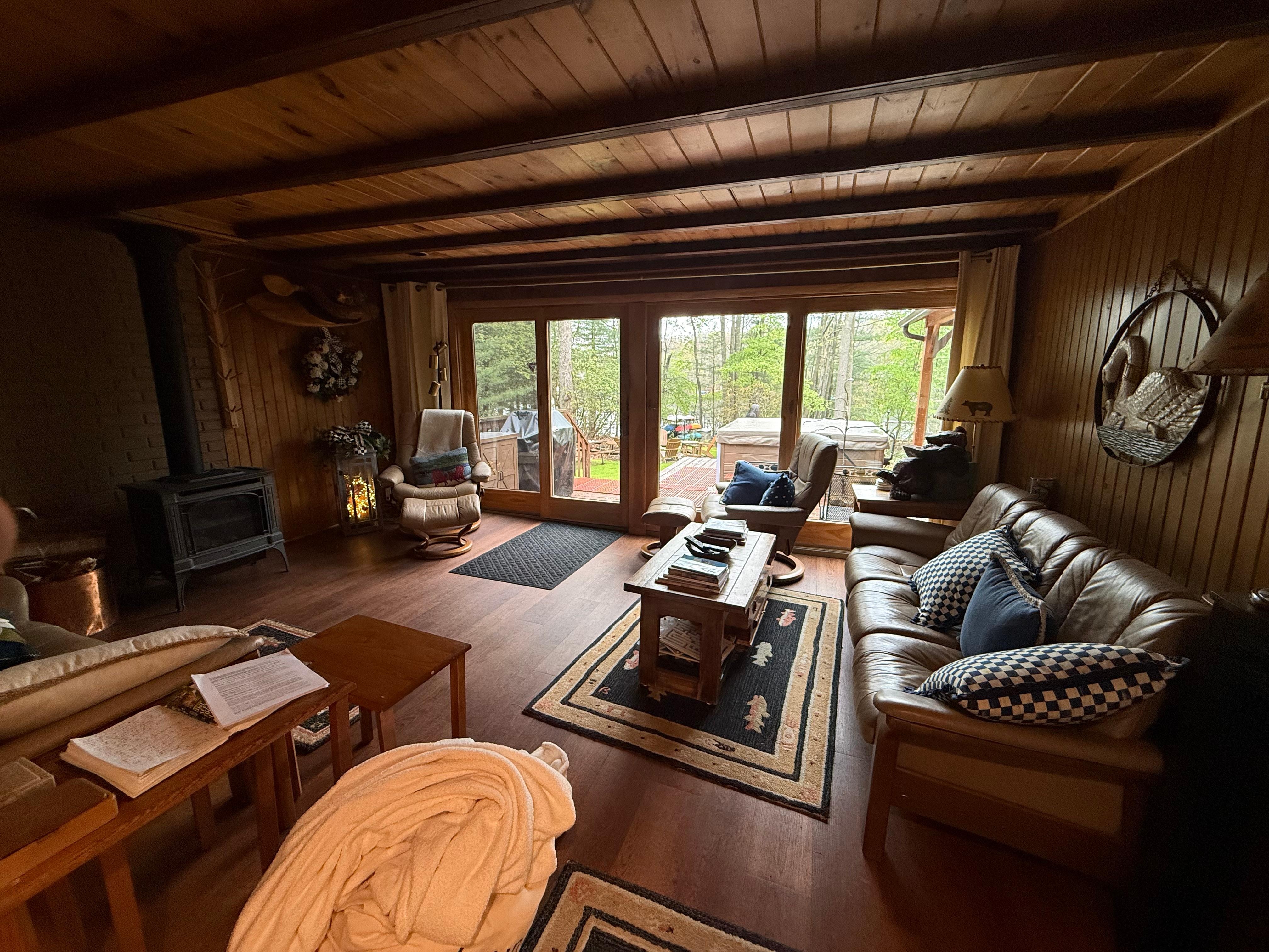 Living room with gas stove on the left and view of lake out the back