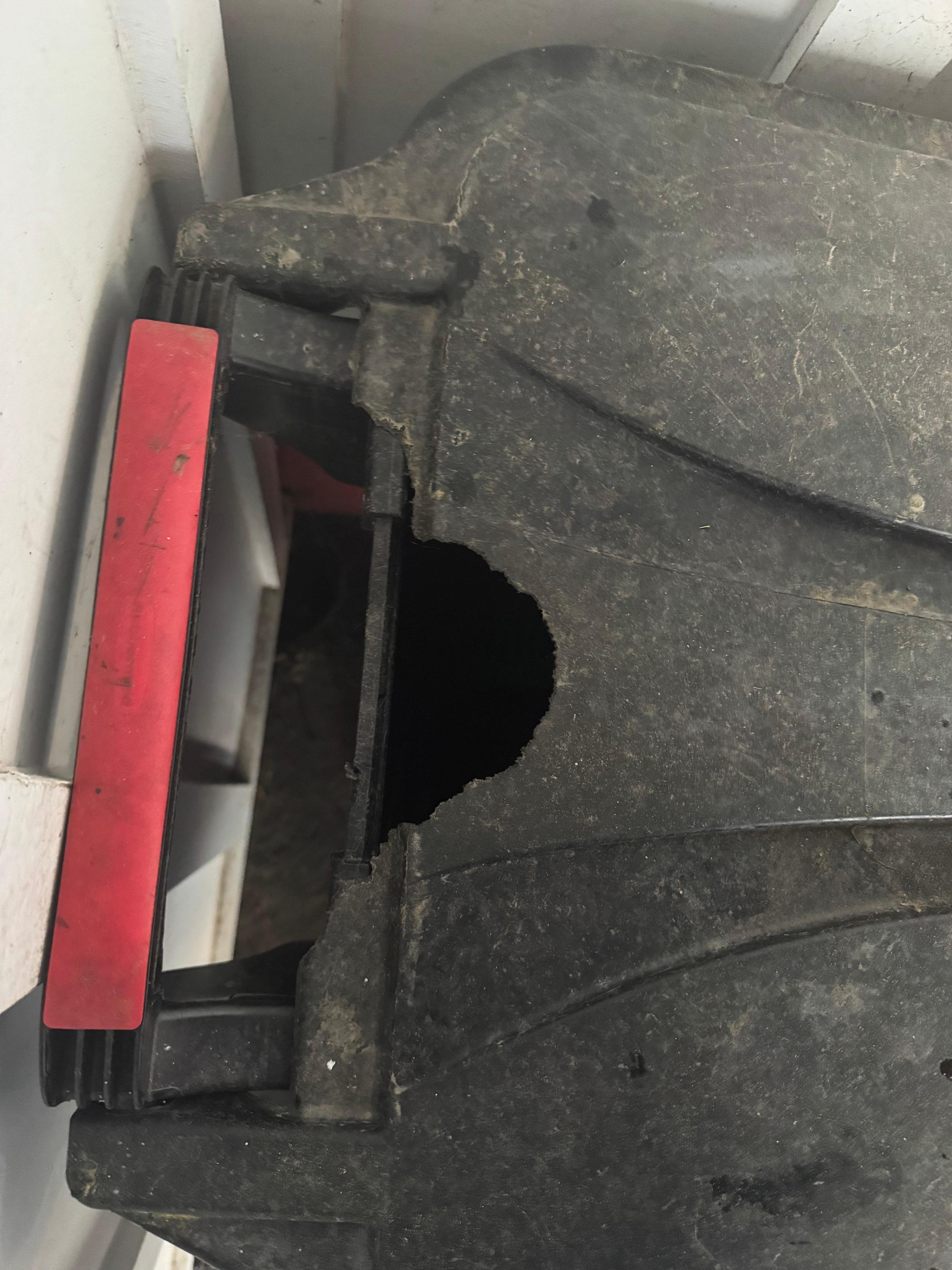 exterior trash can in compact car parking space