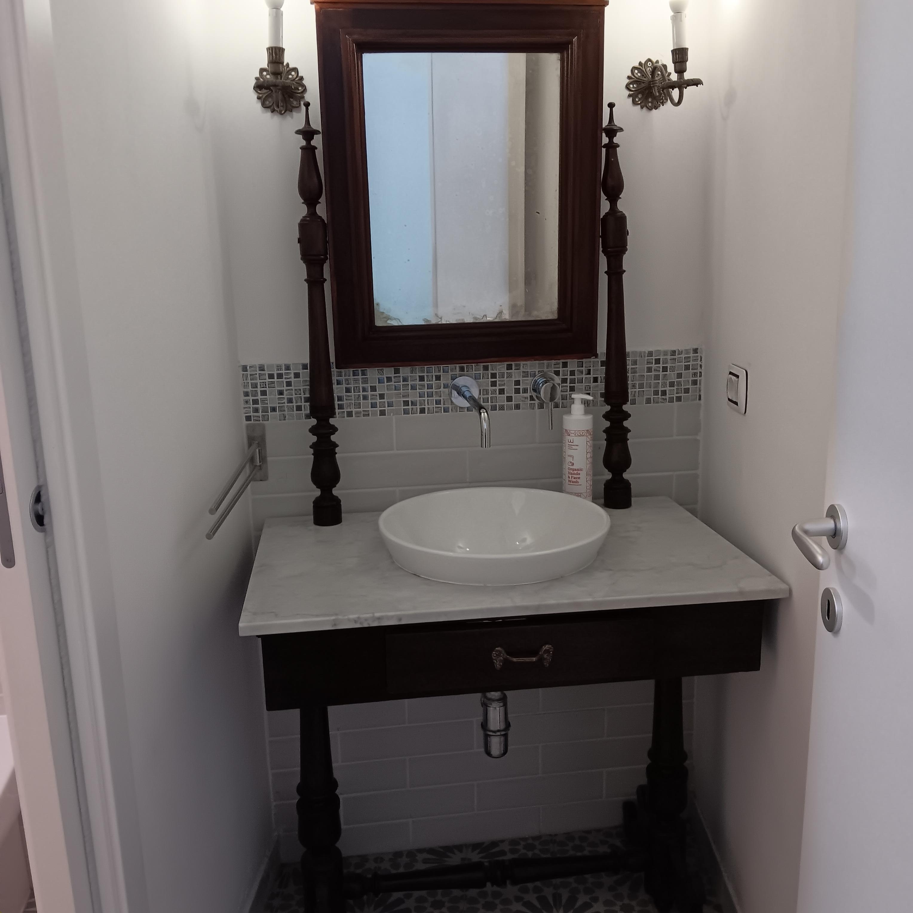 Second bathroom has dim light for applying makeup.