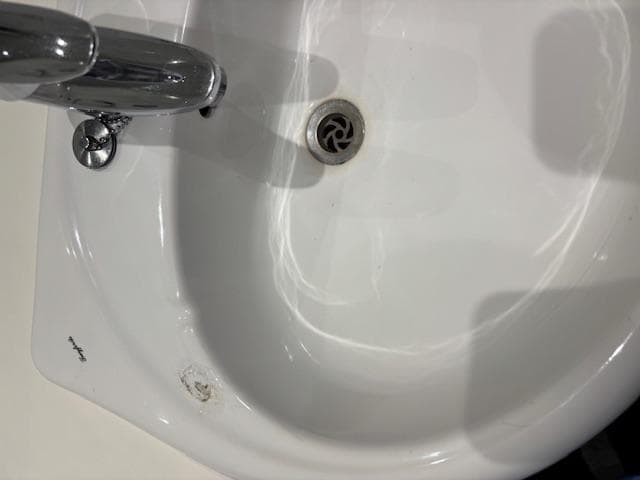 Damage on sink brown marks round plughole