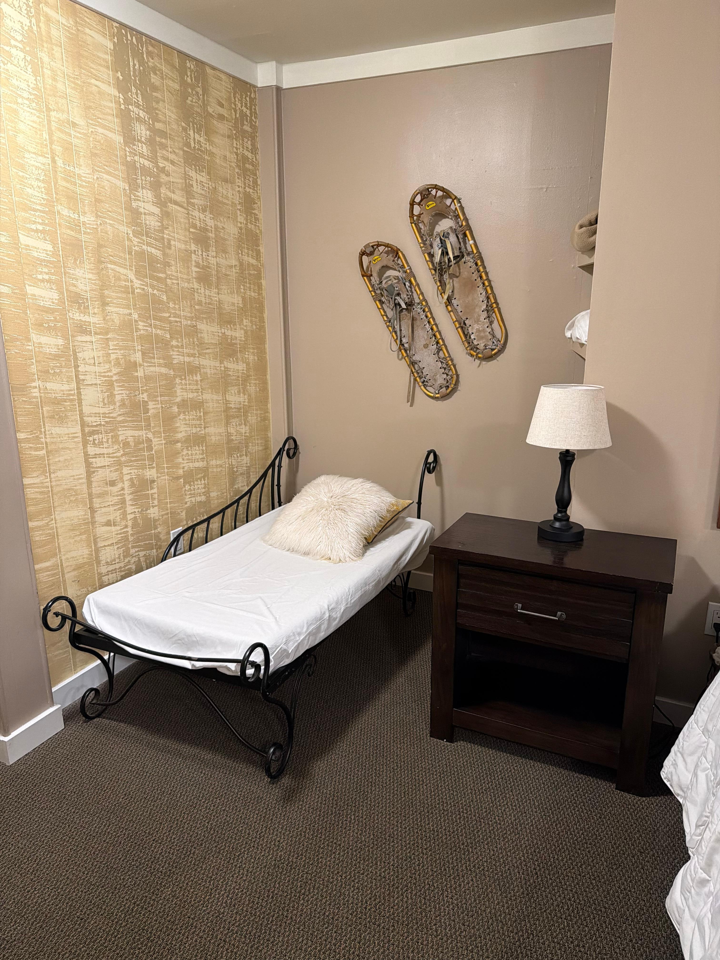 A small bed in the primary room