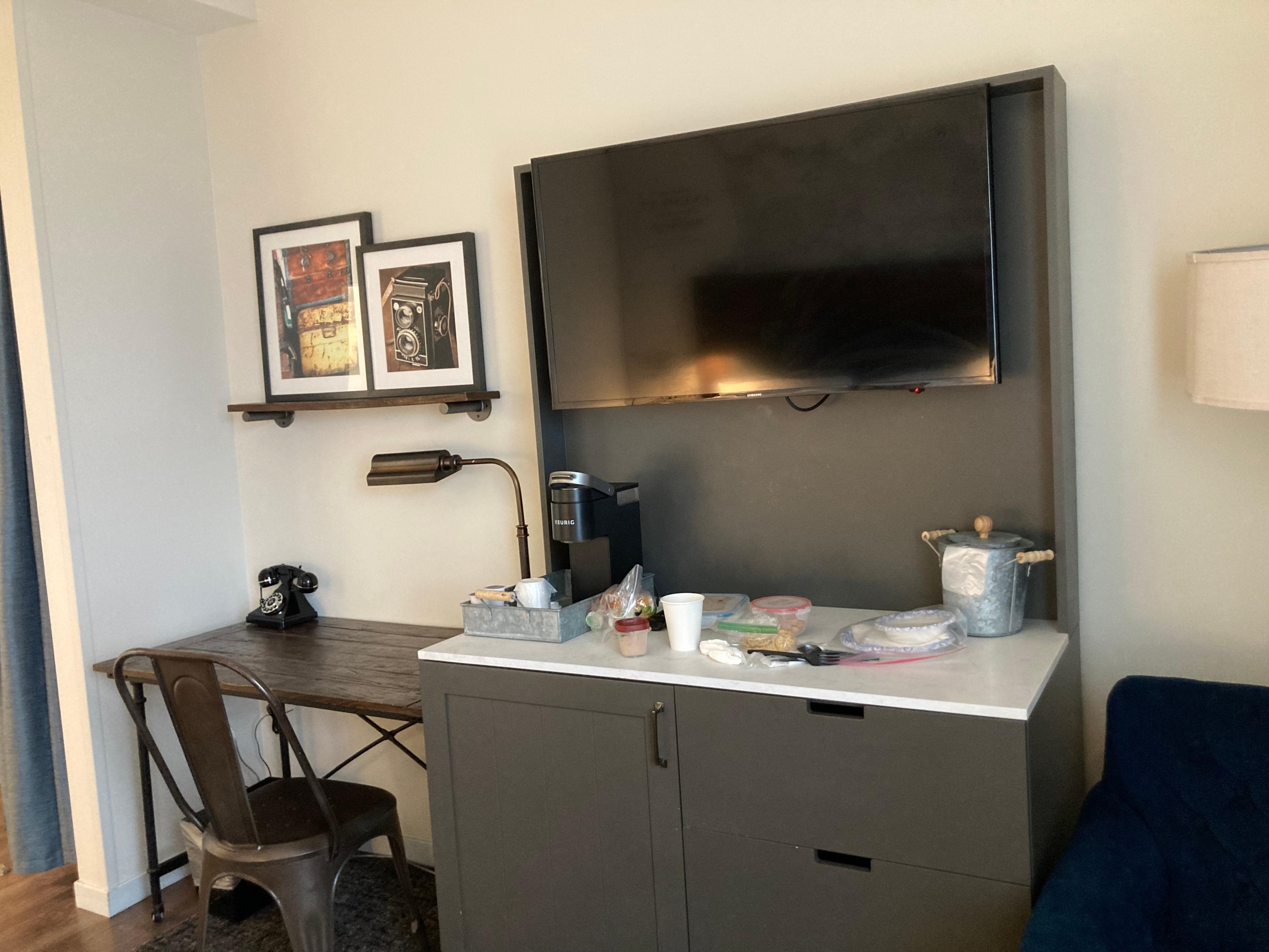 Mini fridge is located in bottom cupboard. Counter is convenient.