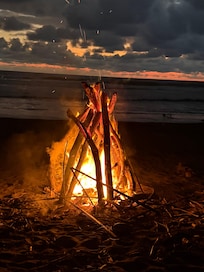 top off the day with a sunset fire on the beach