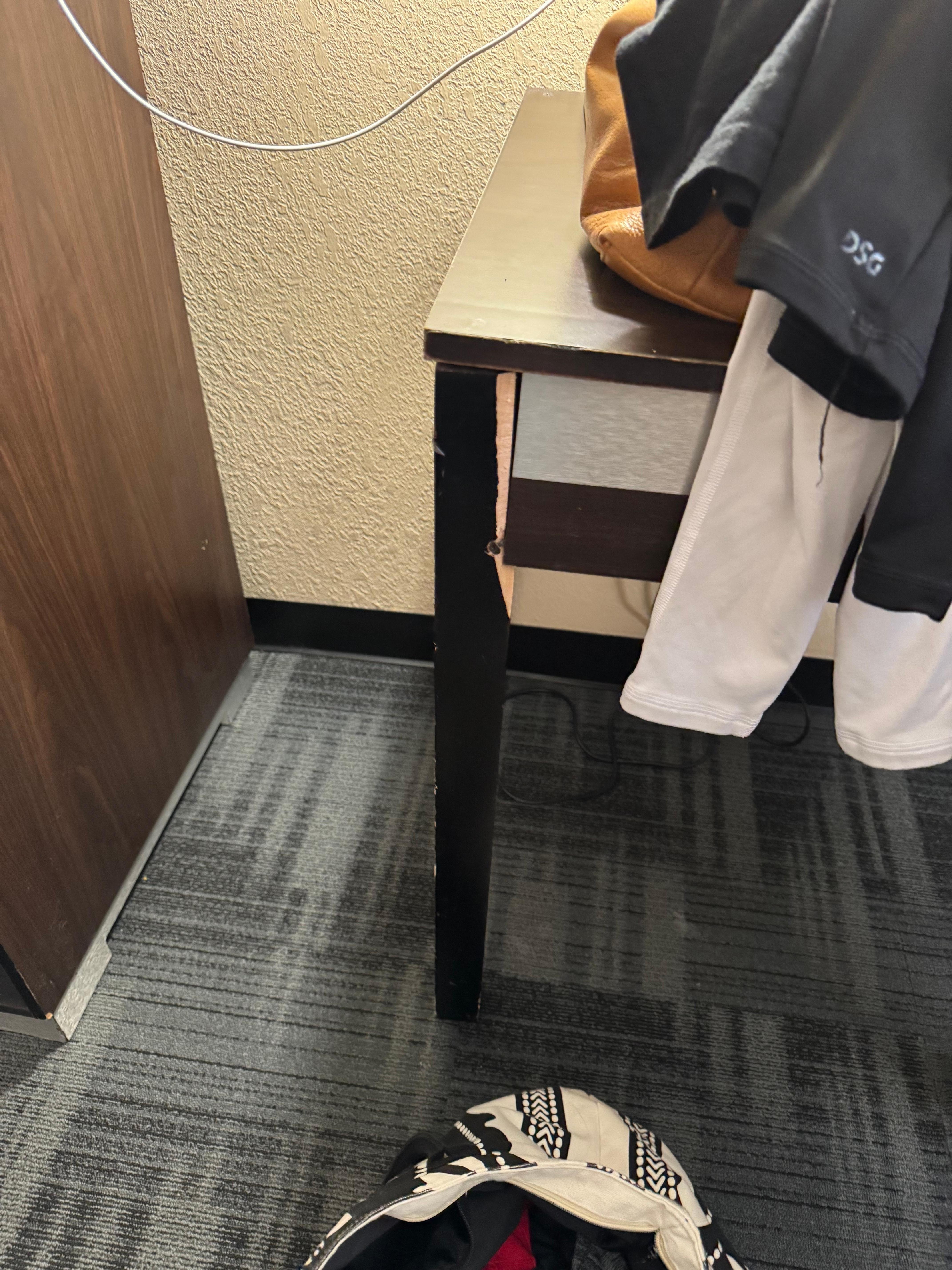 Desk was broken and they used one screw to try and fix it.  Desk top had burn marks in it.  