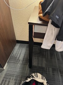 Desk was broken and they used one screw to try and fix it. Desk top had burn marks in it.