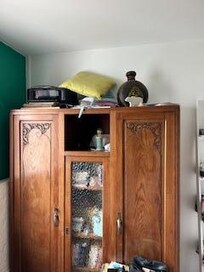 junk on top of armoire in the bedroom.