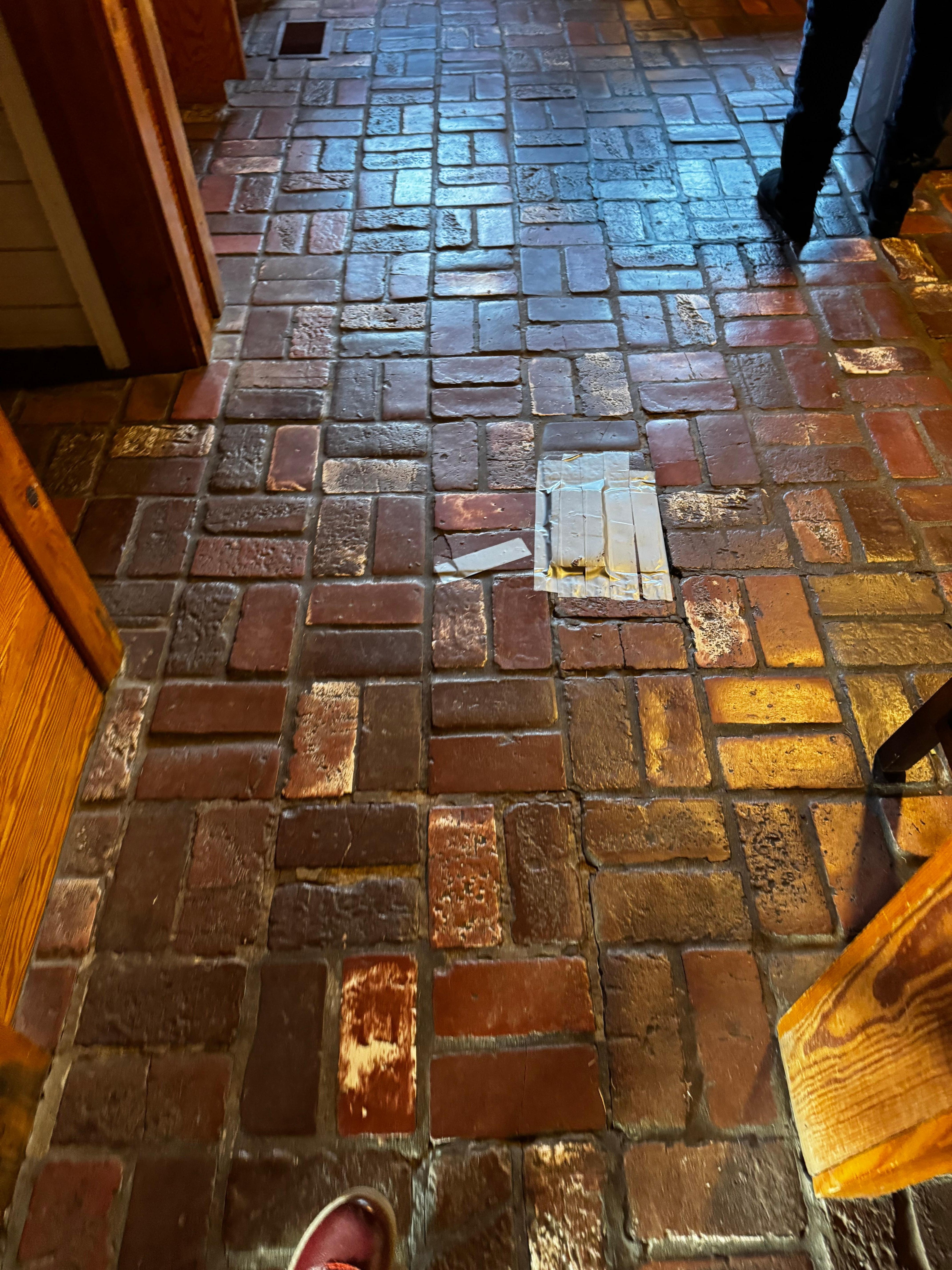 Broken brick floors with duct tape.