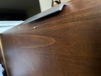 Screw coming through the door to the fridge