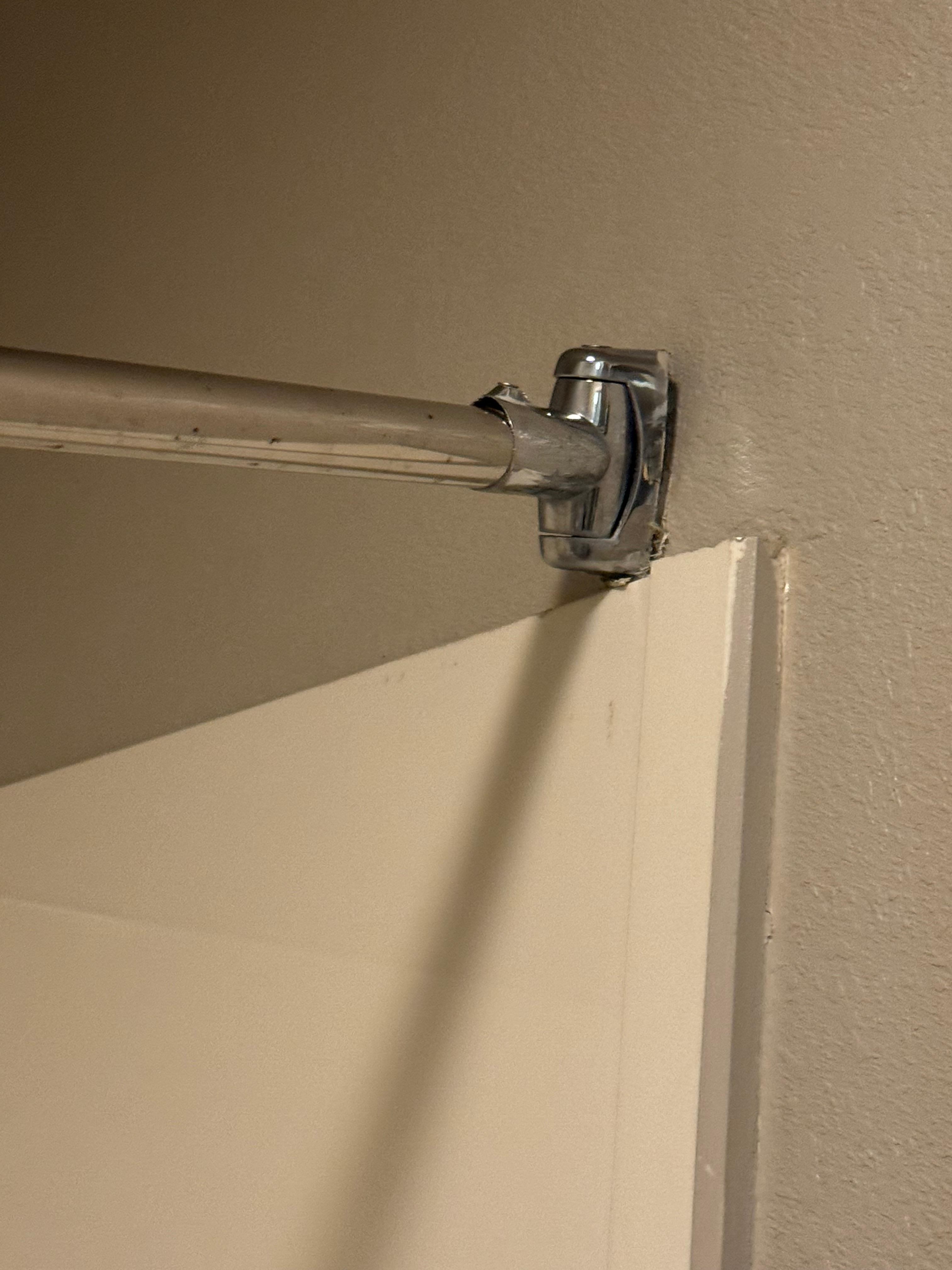 Shower rod is not hanging correctly, so curtain falls to the middle. 