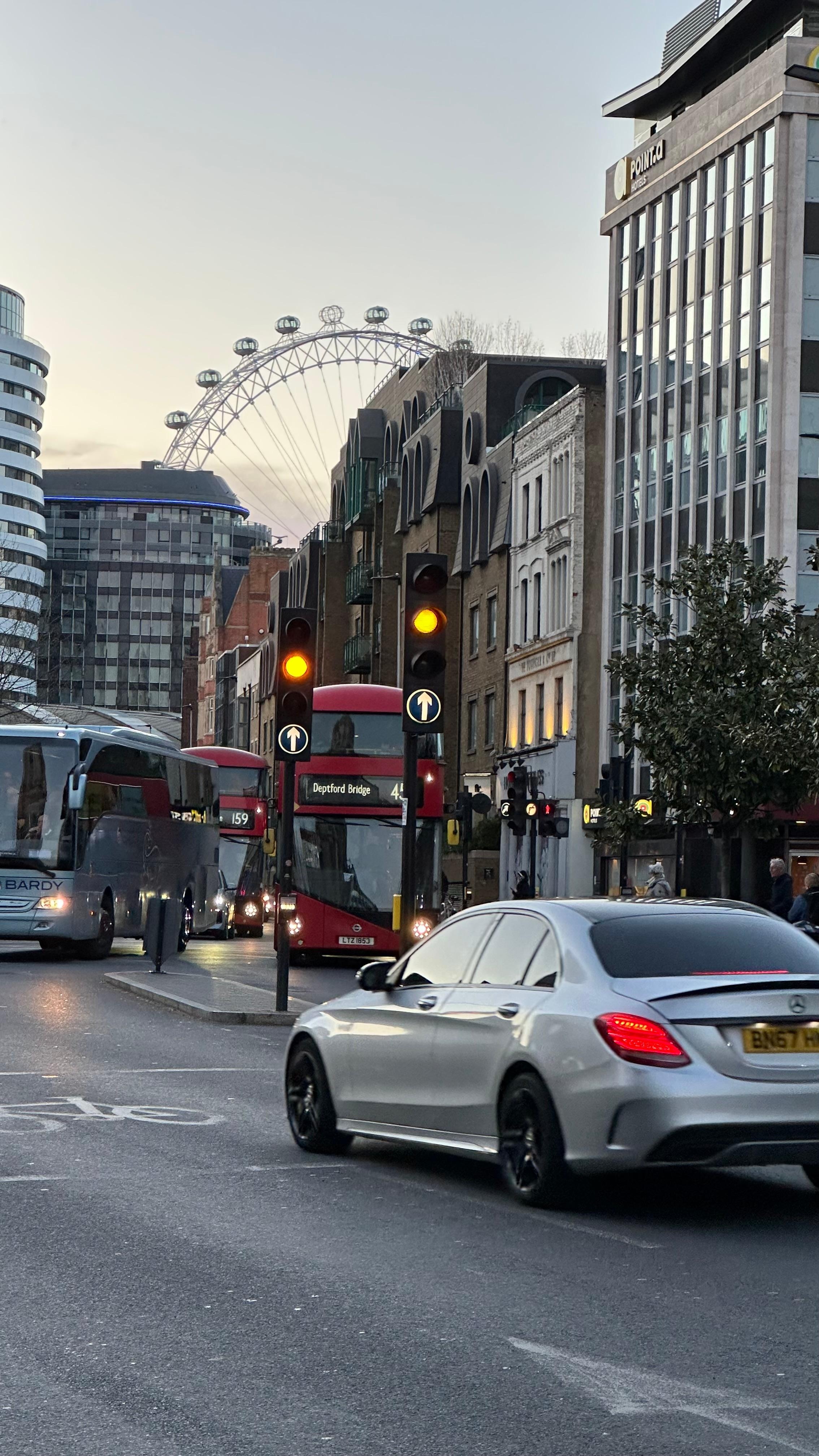 The hotel is the building to the right of the bus