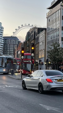 The hotel is the building to the right of the bus