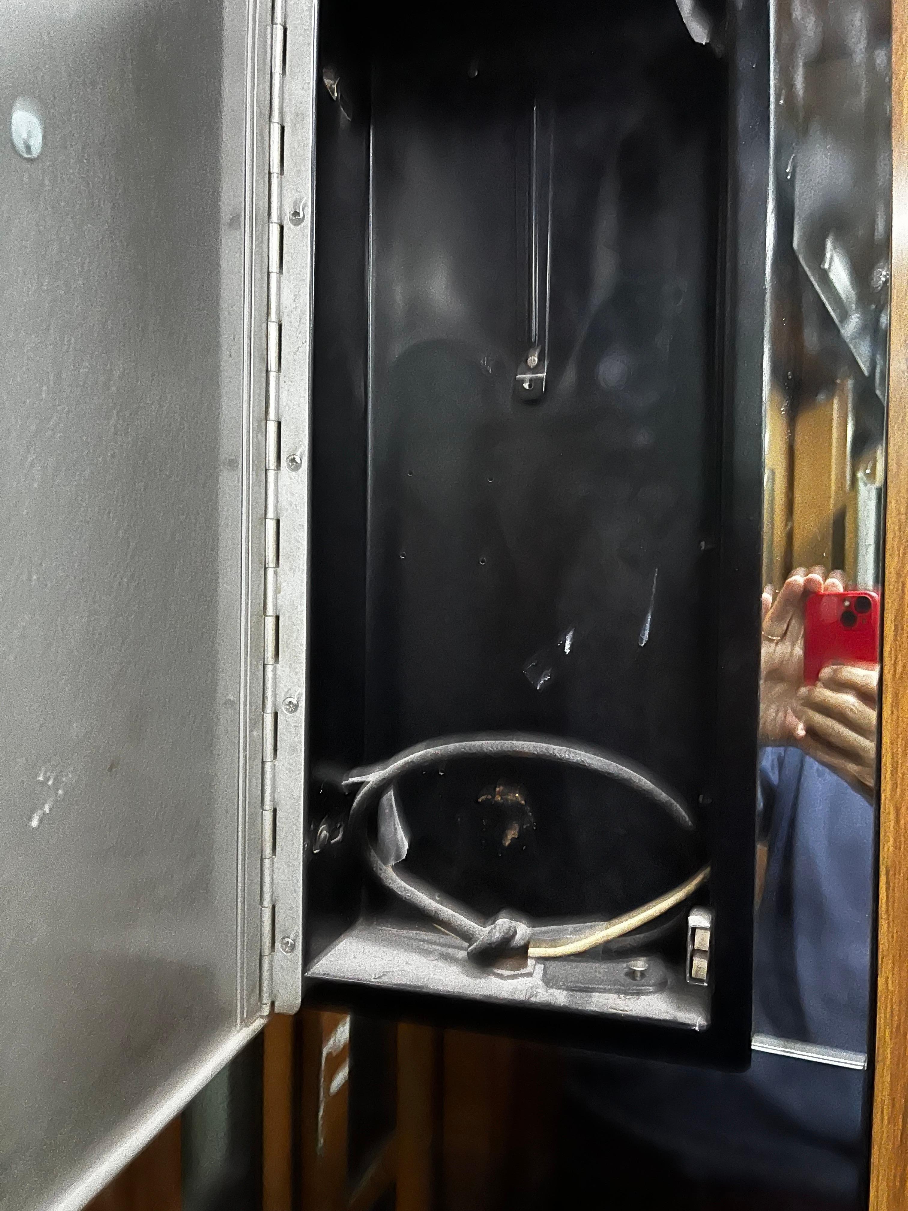 empty cabinet in the lift where the emergency phone should be