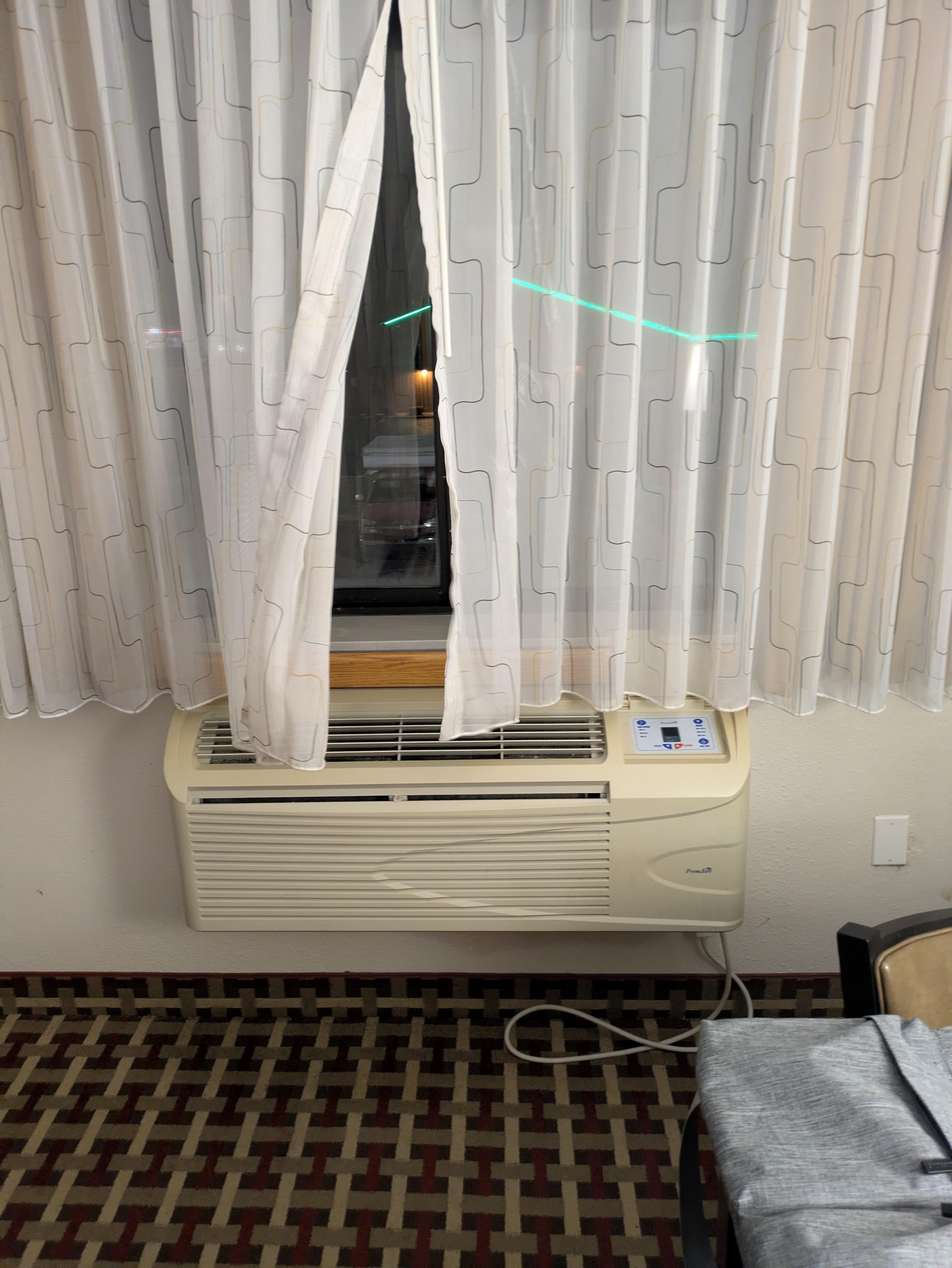 Heater blowing open curtains.