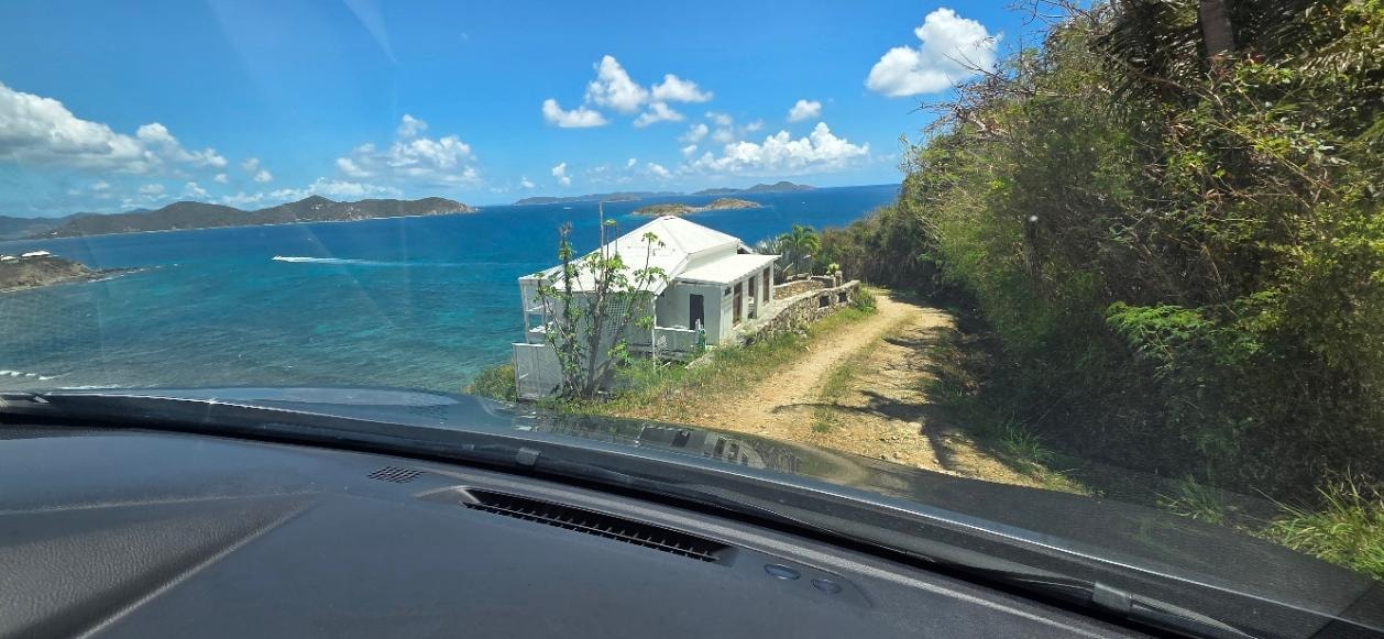 View of the house coming down the road to it.