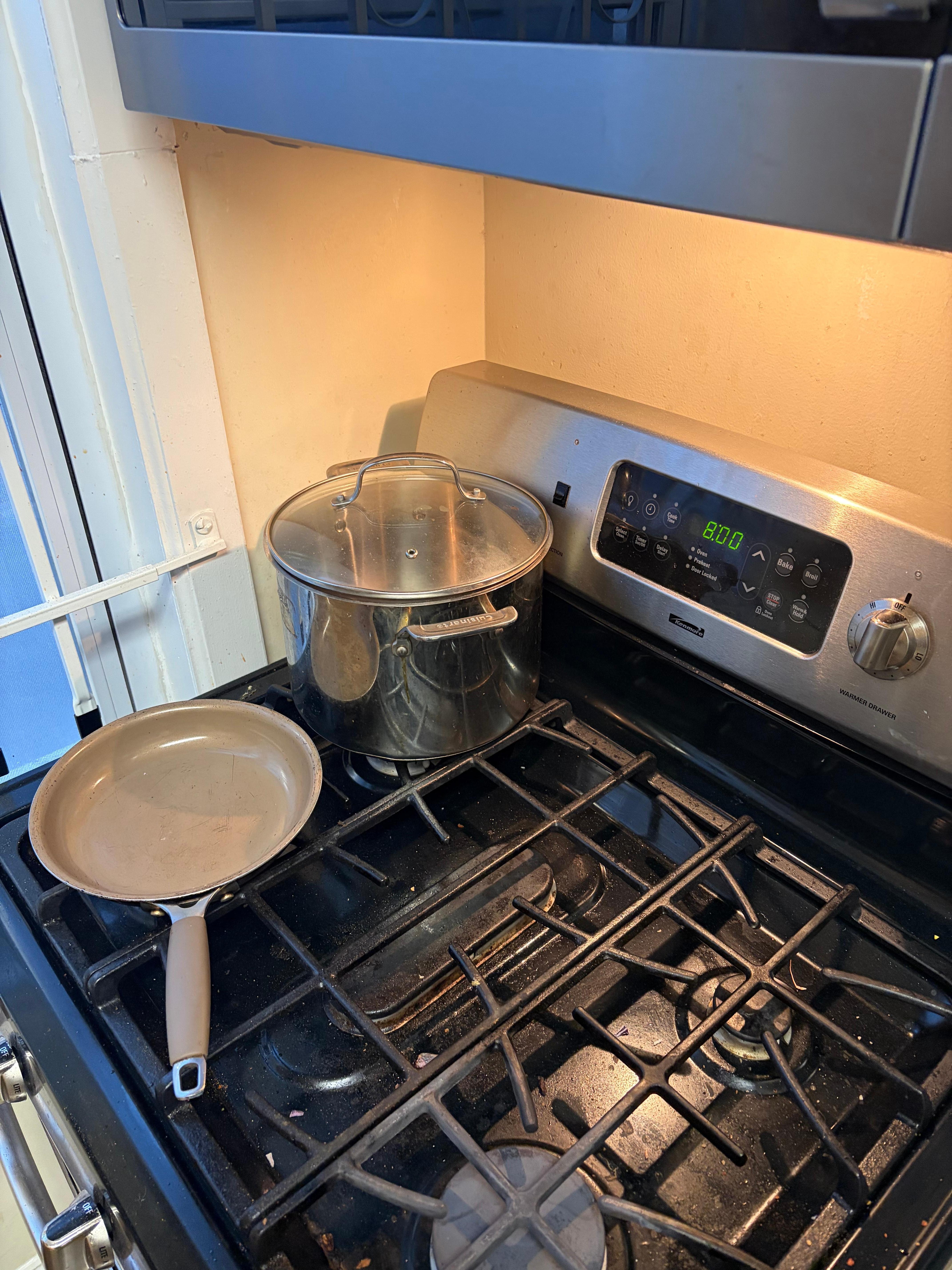 Stove top with dirty pots and pans