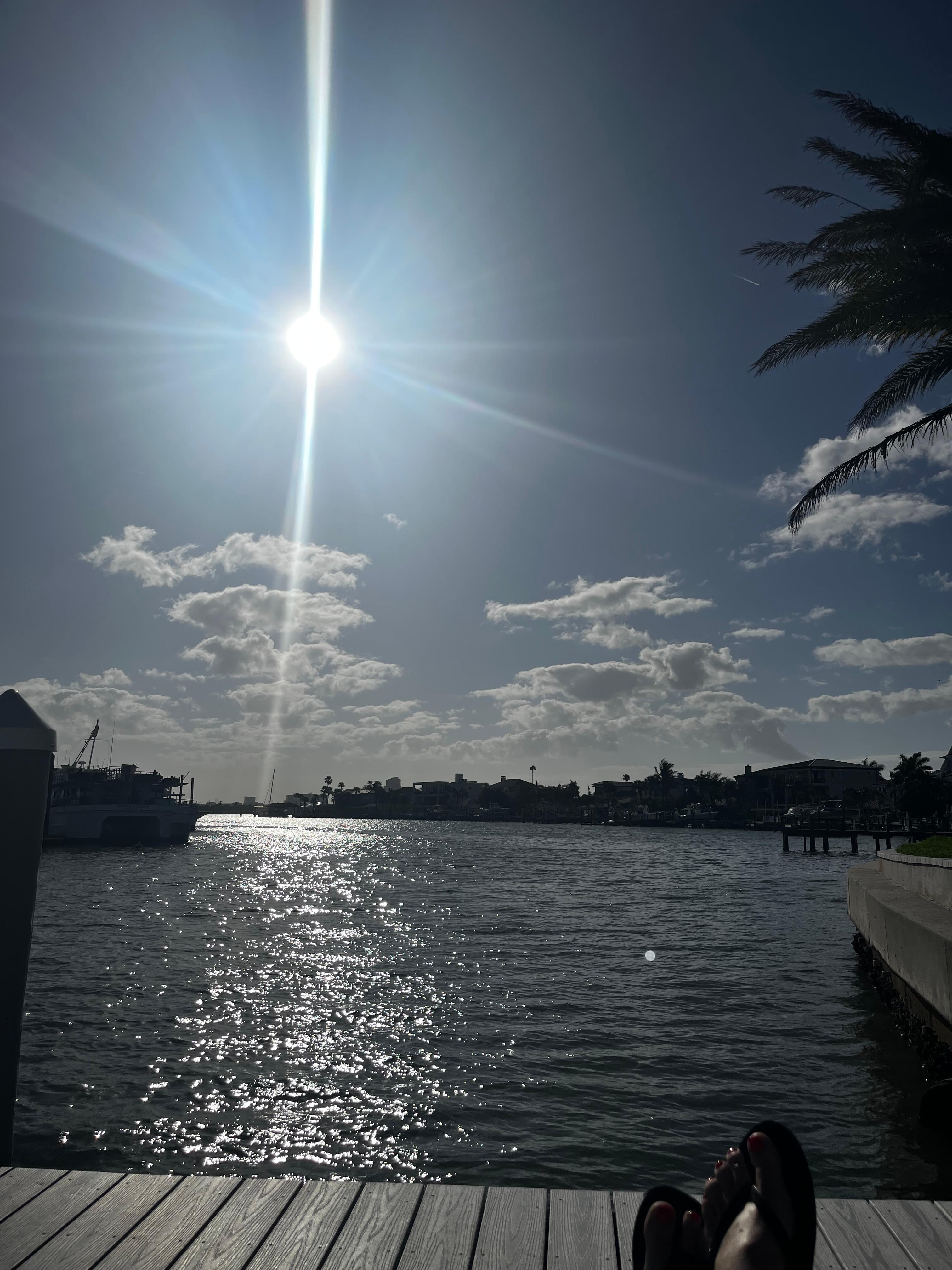 The view sitting by the pool on the water. 