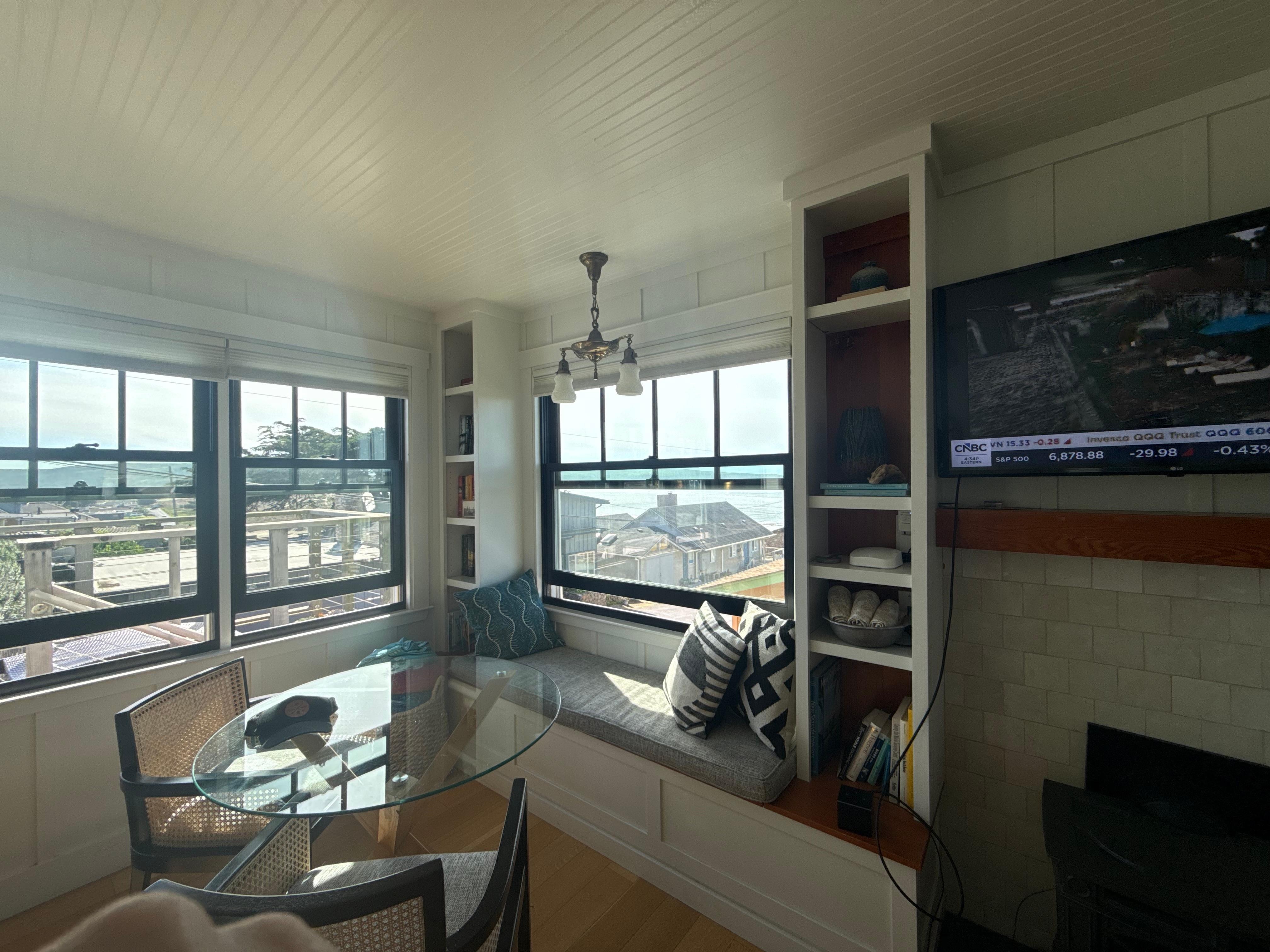 living area with table for four and a window seat! 