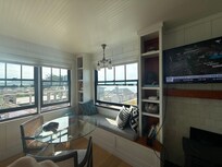 living area with table for four and a window seat!