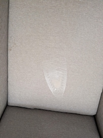 Chair with iron burn mark and tear