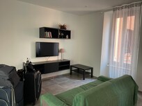 Living room with a couch and tv.