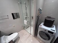Bathroom with washing machine and dryer