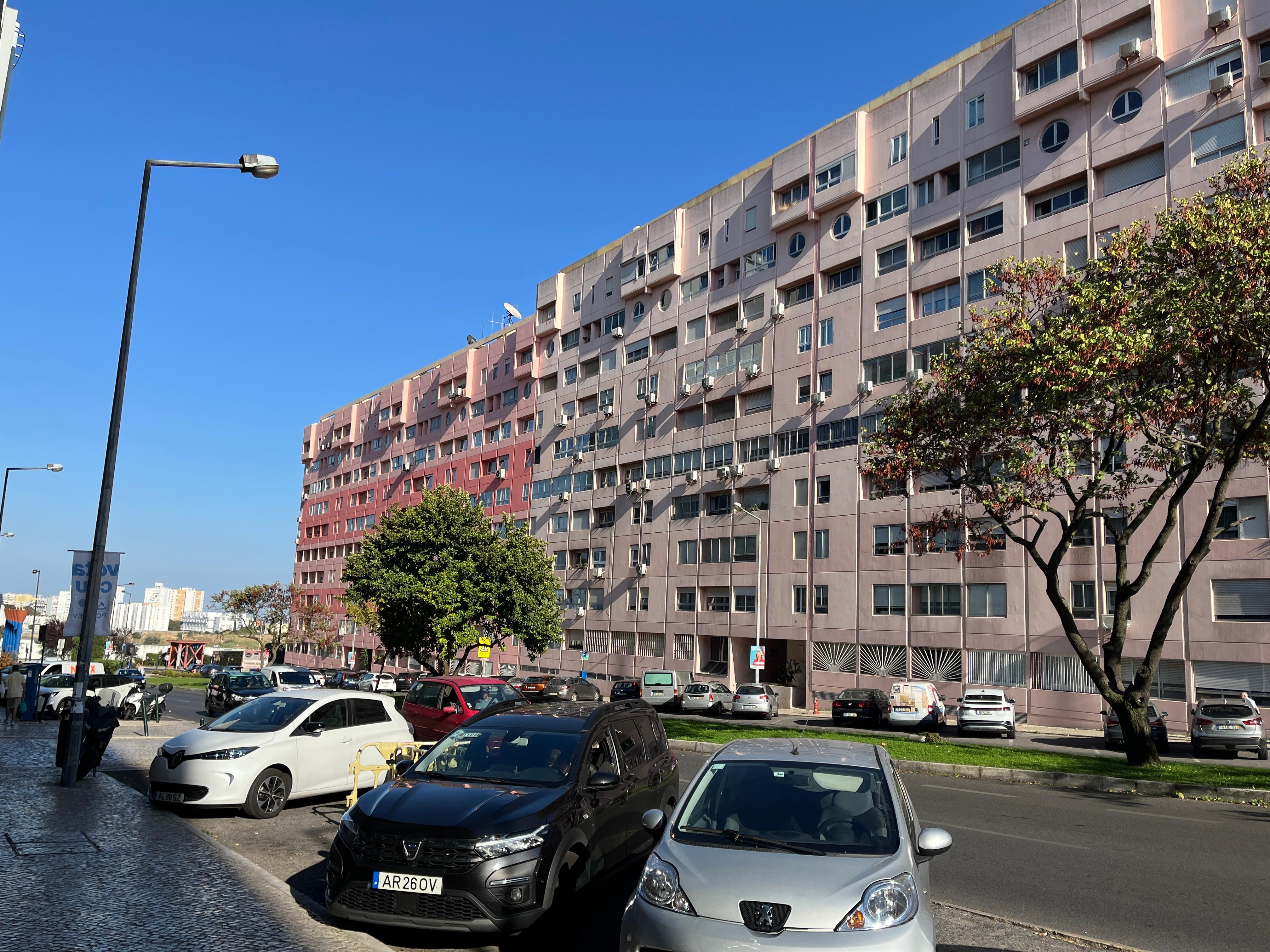 The apartment from across the street. 2nd floor from the top, directly over the silver car.