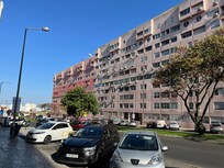 The apartment from across the street. 2nd floor from the top, directly over the silver car.