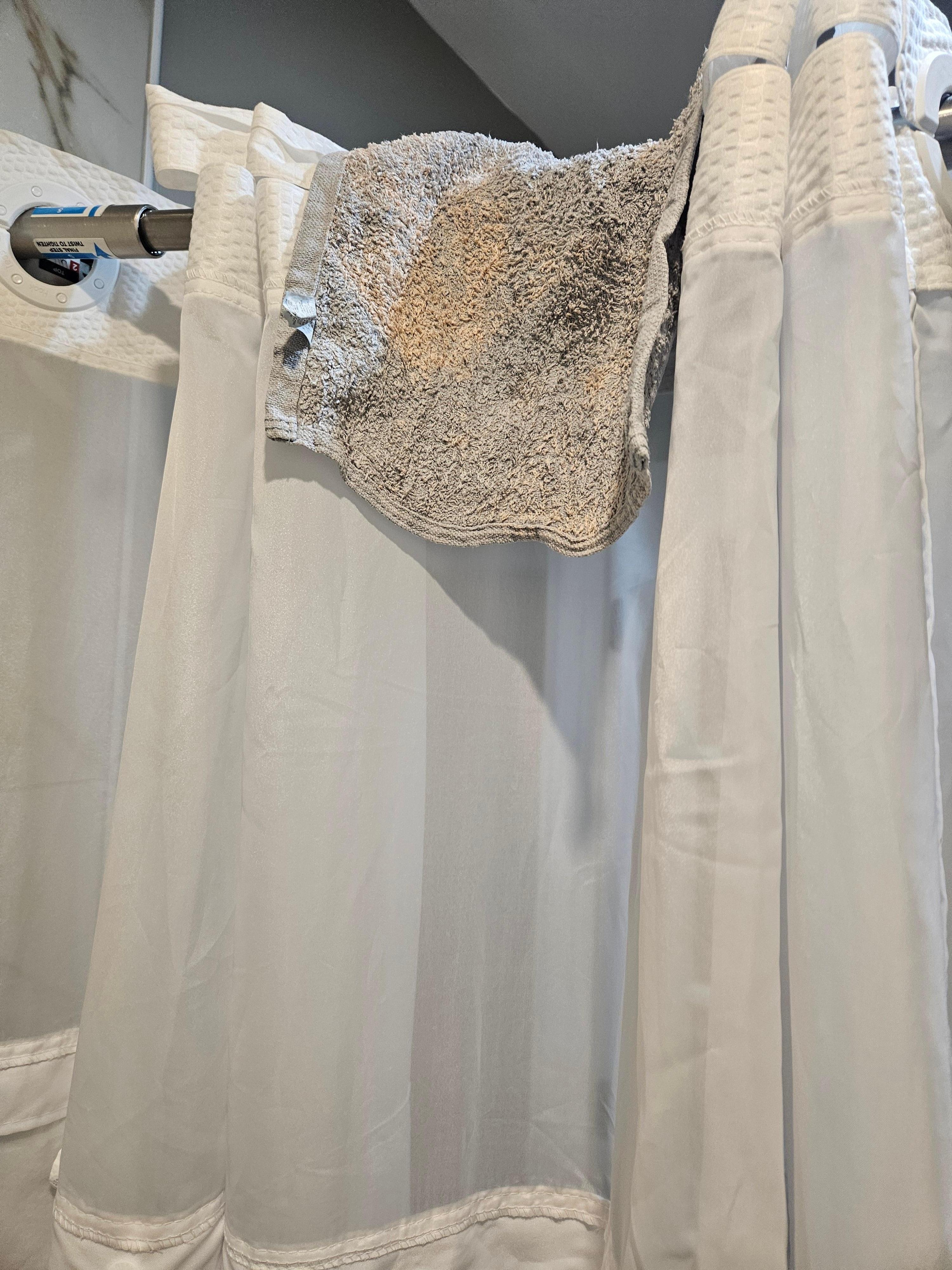 Dirty washcloth cloth in shower.