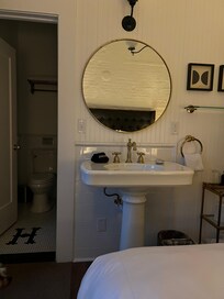 The sink at the foot of the bed