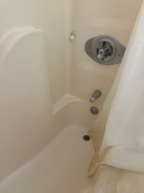 Nasty, wet, moldy shower curtain and a hole plugged with toilet paper! So gross - and the smell was overwhelming - no way we were staying here