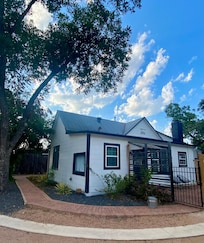 Corner view of the Main House with back gated hot tub area and kitchen door entrance. All right next to the reserved parking spaces.